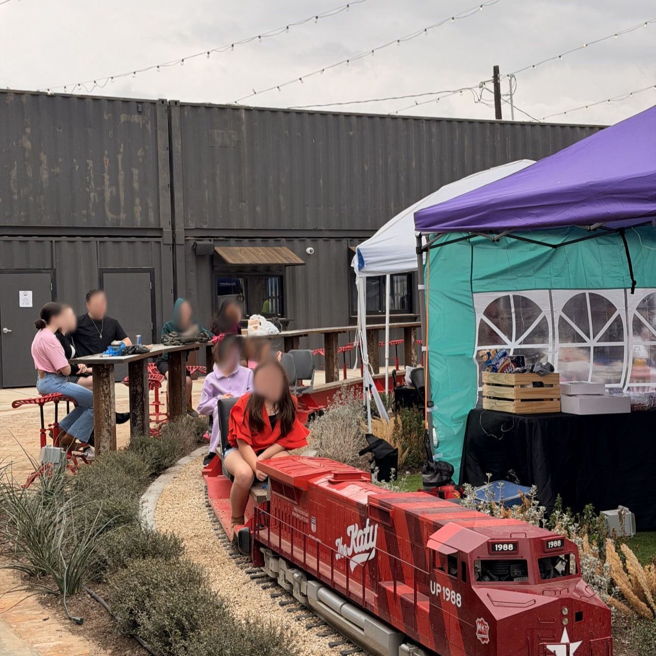 Children riding the small red train at The Dryer